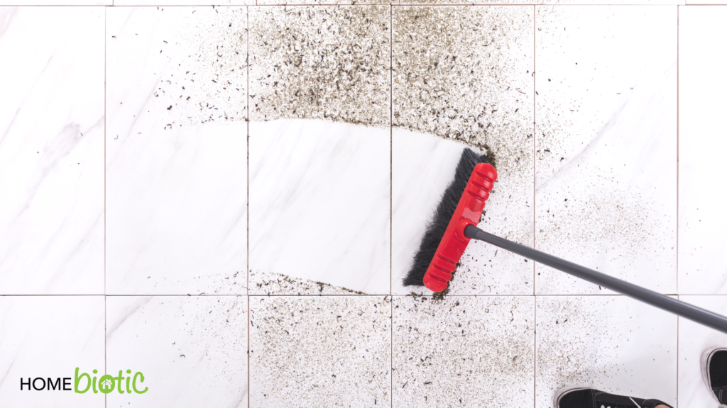 Soil-Based Microbes Provide Natural Mold Protection | Sweeping dirt off of a tile floor