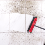 Soil-Based Microbes Provide Natural Mold Protection | Sweeping dirt off of a tile floor