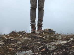person in hiking boots standing on dirt - homebiotic