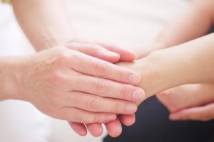 mother holding child's hands - Homebiotic - lyme disease resources