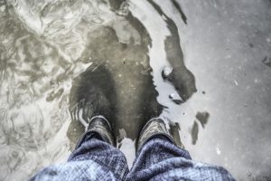 standing in flood waters in jeans - homebiotic
