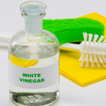 white vinegar with cleaning tools